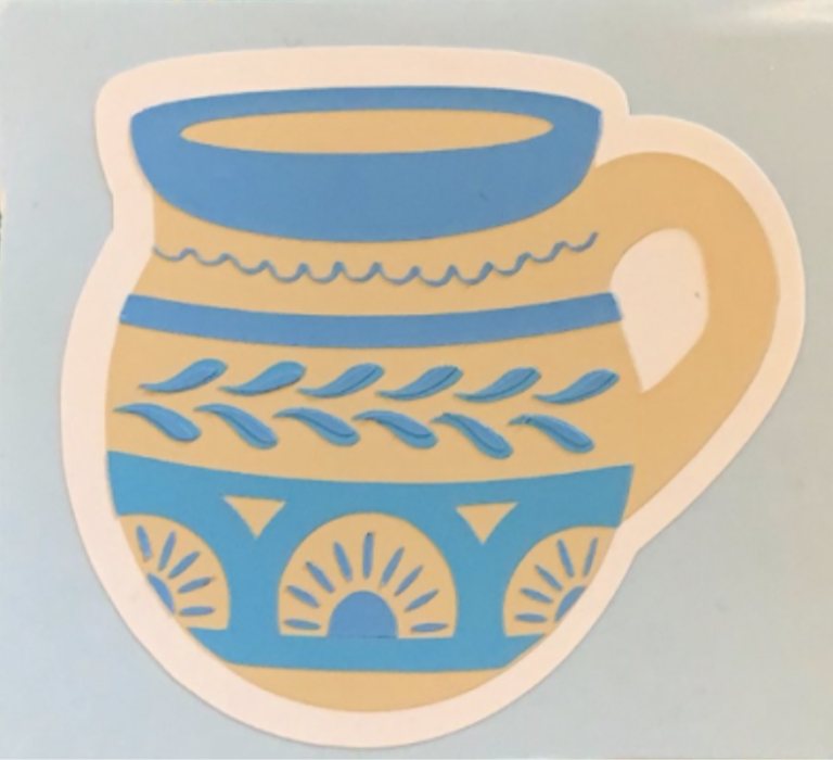 Close-up scan of the finished sticker showing the blue rim, leaf pattern and sunburst band