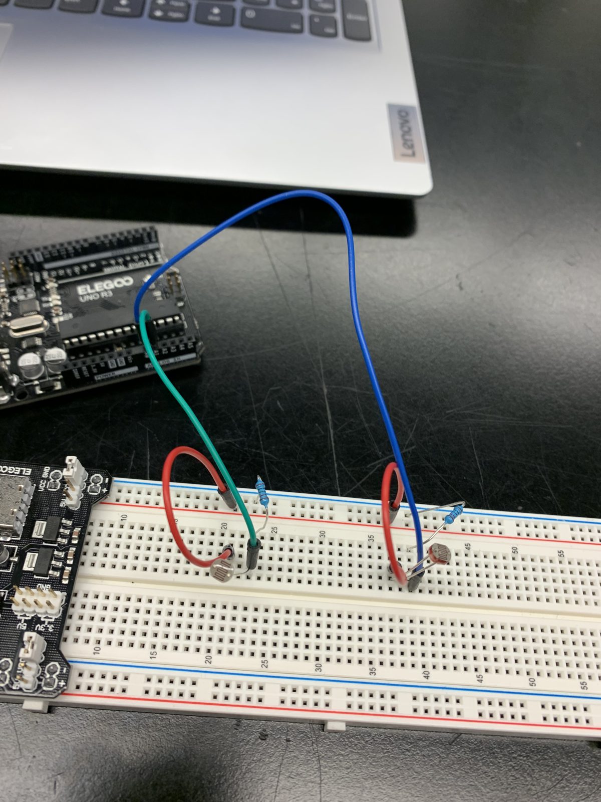Two photoresistors on a breadboard, each with a resistor, wired to an Arduino.